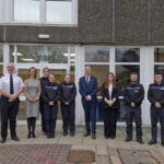Clive Grunshaw and group of officers outside office building
